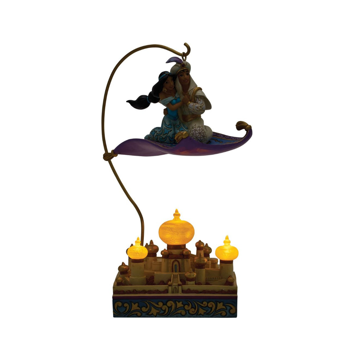 Aladdin and Jasmine soar above Agrabah on the magic carpet in this breath-taking Jim Shore scene. With an LED palace glowing below them, the pair captures the romance and wonder of Disney's unforgettable adventure.