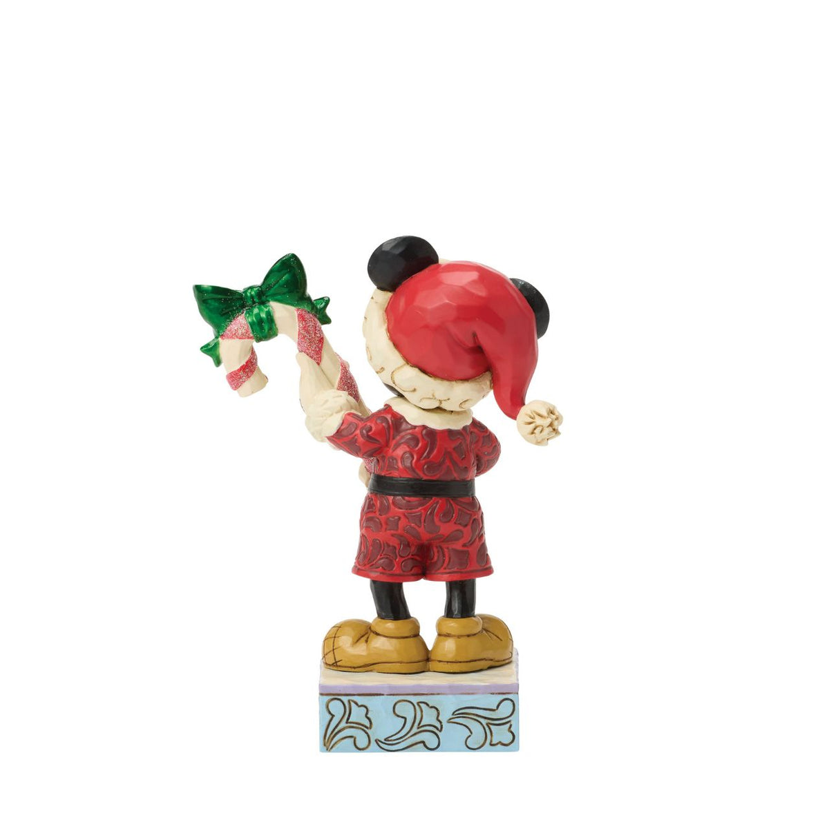Mickey holds a giant candy cane in this festive Jim Shore design. With a playful pose, Mickey is dressed in a Santa hat and red coat with rosemaling details, he adds a touch of holiday sweetness and Disney magic to your Christmas traditions.