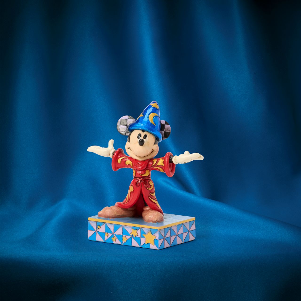 Celebrating the 85th anniversary of Fantasia in 2025, this Jim Shore Mickey Mouse is striking in red robes adorned with real gold cord and intricate rosemaling. With his sorcerer's hat, Mickey embodies the magic and wonder of the beloved classic.