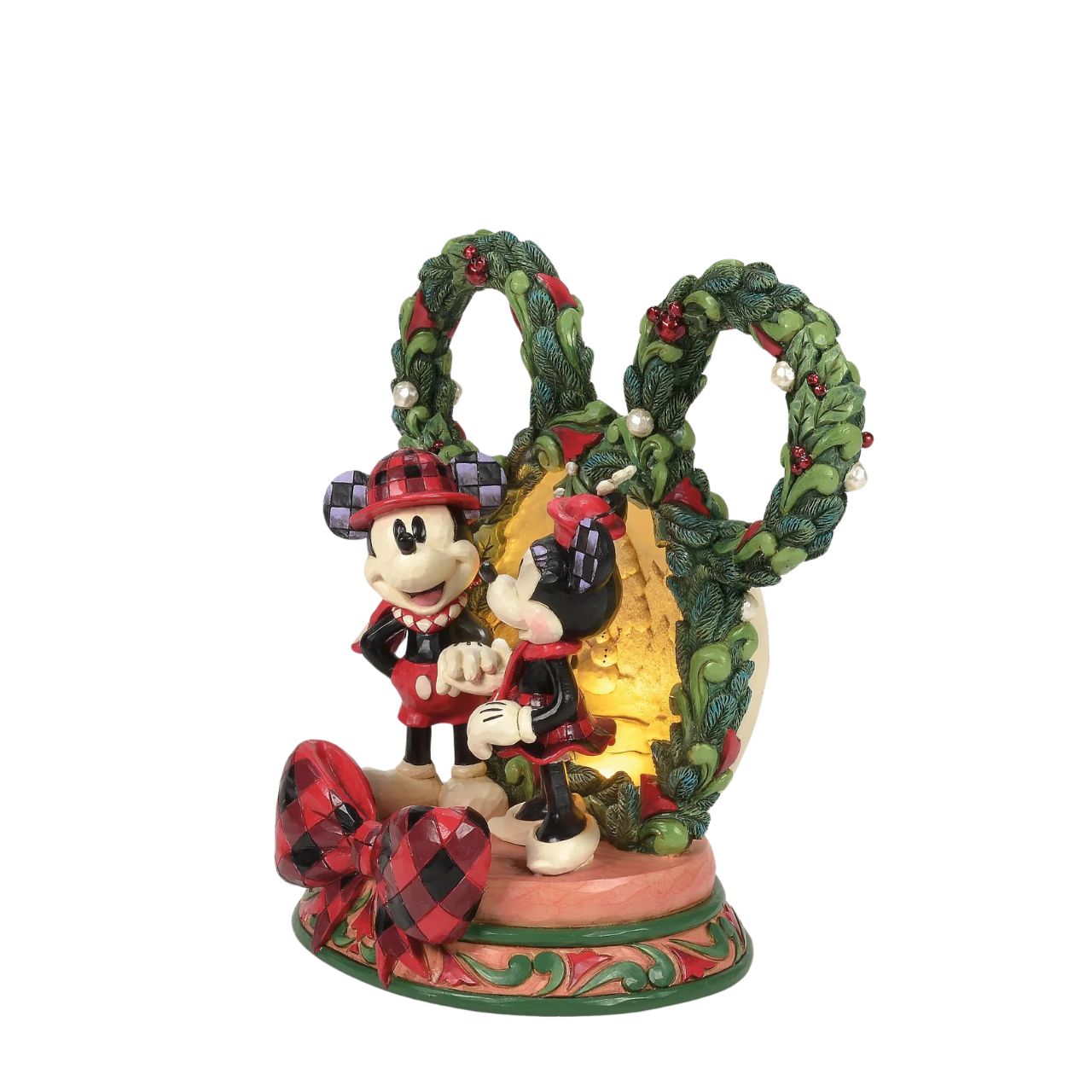 This delightful Jim Shore Christmas scene captures Mickey and Minnie holding hands beneath a glowing LED diorama, framed by a festive Mickey-shaped garland adorned with berries and pearl accents. It radiates seasonal magic with holiday charm.
