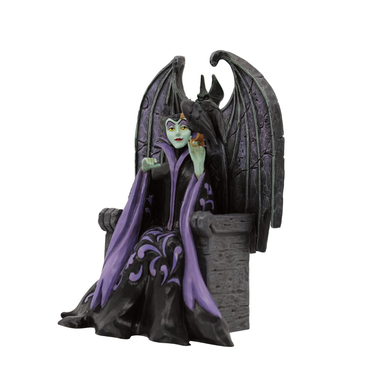 Maleficent sits atop her throne with her raven, Diavel. Dressed in her signature black with horned headdress, she is every piece the iconic villain from Sleeping Beauty. Designed by Jim Shore for his Disney Traditions collection.