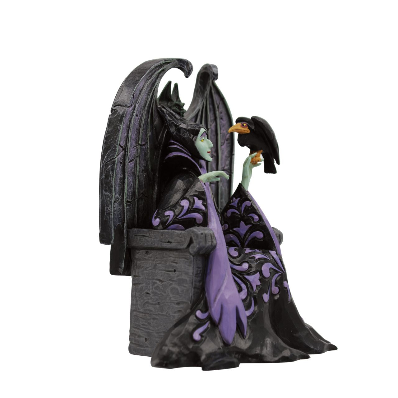 Maleficent sits atop her throne with her raven, Diavel. Dressed in her signature black with horned headdress, she is every piece the iconic villain from Sleeping Beauty. Designed by Jim Shore for his Disney Traditions collection.