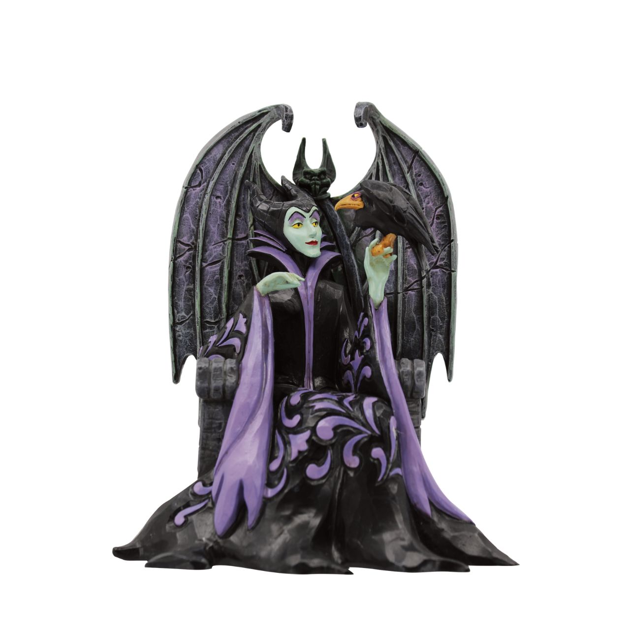 Maleficent sits atop her throne with her raven, Diavel. Dressed in her signature black with horned headdress, she is every piece the iconic villain from Sleeping Beauty. Designed by Jim Shore for his Disney Traditions collection.