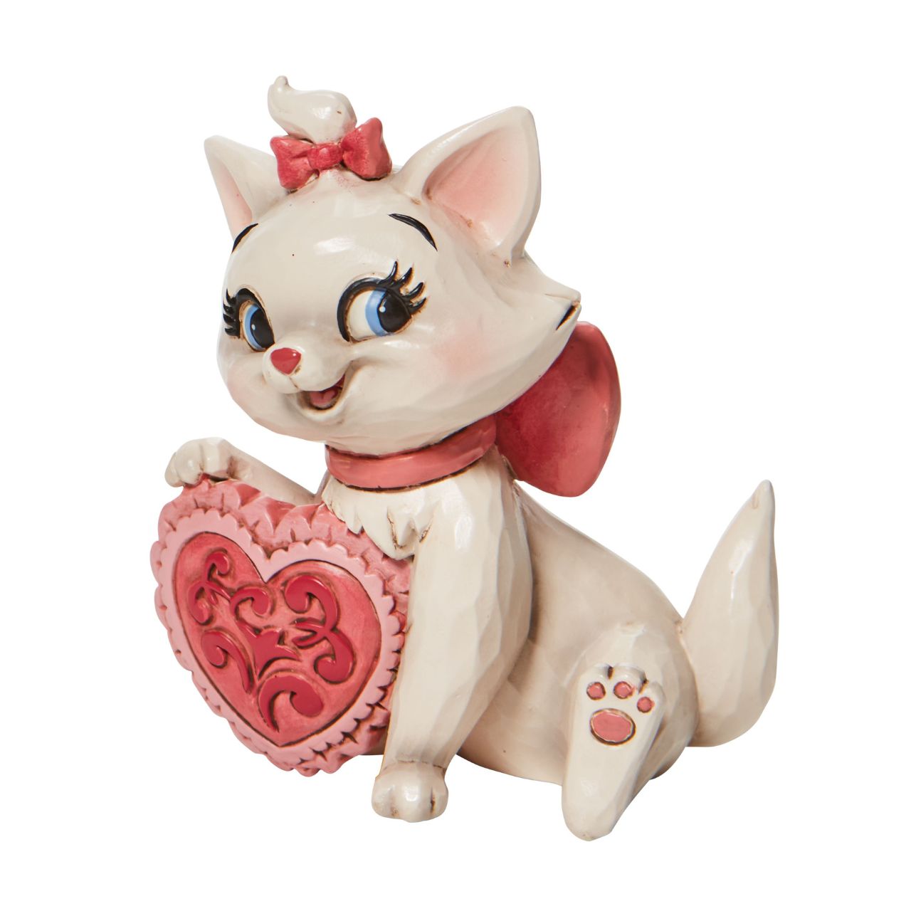 Jim Shore The Aristocats Marie Heart Mini Figurine  The 1970 Walt Disney classic, The Aristocats, followed three kittens and their mother across the Parisian countryside after being cat-napped from their home. Marie, the only daughter of the bunch, holds a pink heart in this sweet Jim Shore figurine. Packaged in a branded gift box.