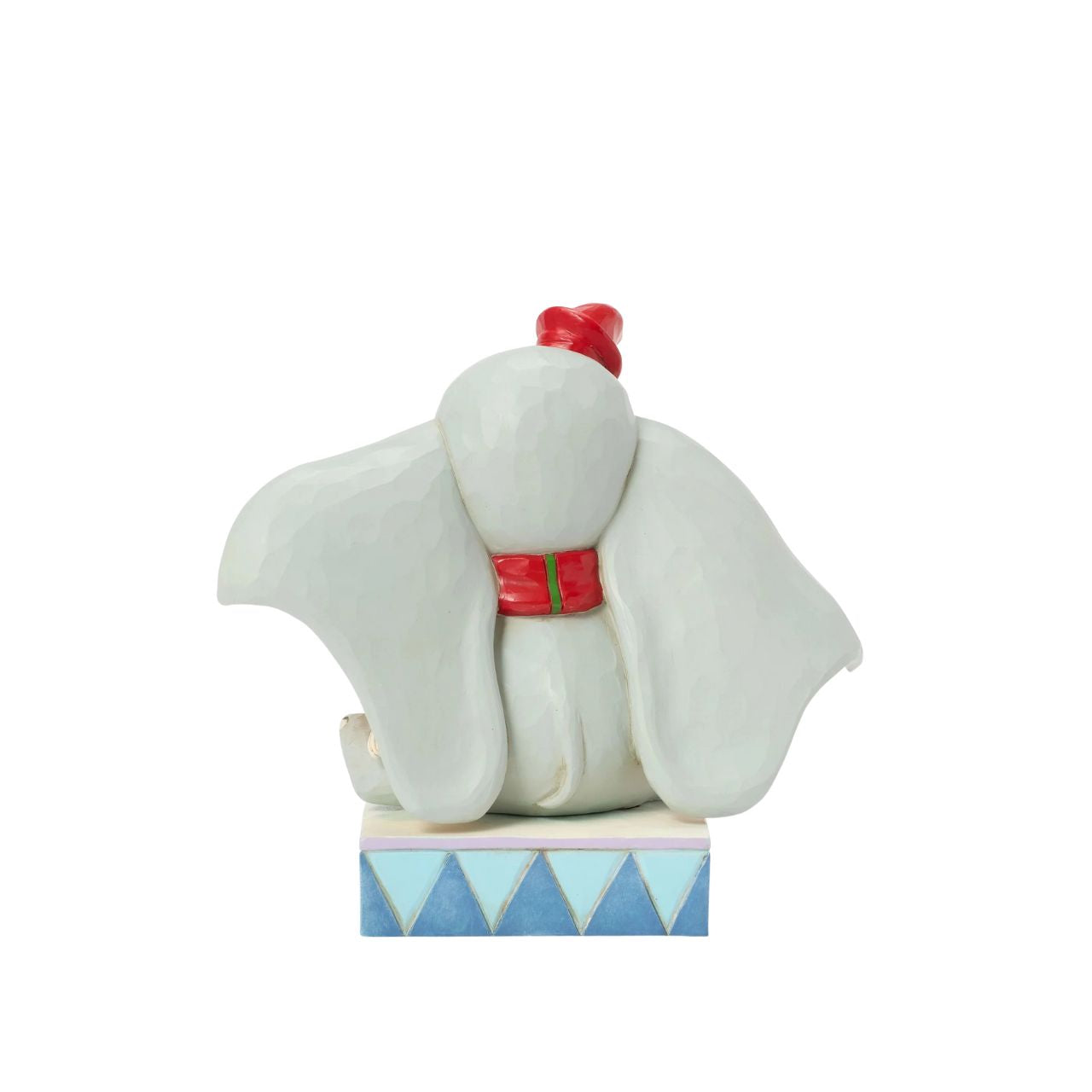 In this heartwarming Jim Shore scene, Dumbo is festively dressed in a red coat and hat as he joyfully decorates a miniature Christmas tree with a real working bell in his trunk. Capture the spirit of the season with Dumbo's playful spirit.