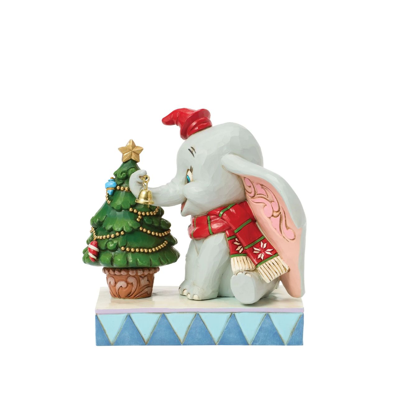 In this heartwarming Jim Shore scene, Dumbo is festively dressed in a red coat and hat as he joyfully decorates a miniature Christmas tree with a real working bell in his trunk. Capture the spirit of the season with Dumbo's playful spirit.