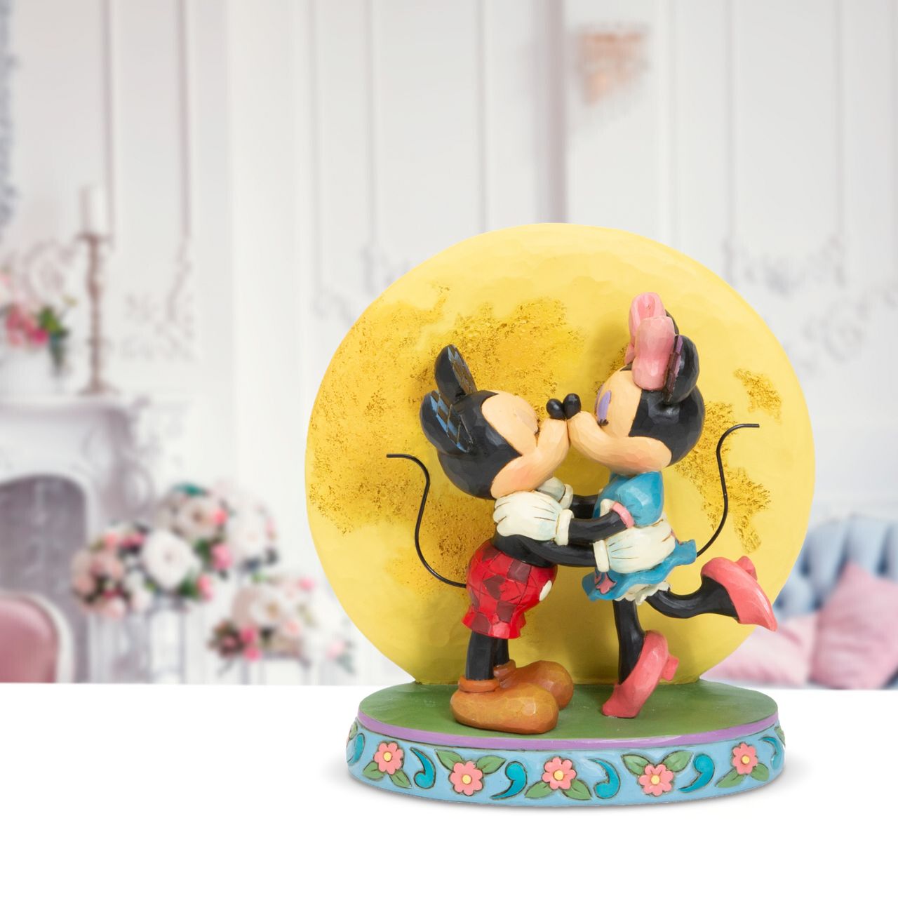 Disney Traditions Magic and Moonlight Mickey and Minnie with Moon Figurine  This delightful figurine portrays Mickey & his sweetheart Minnie dancing in the moonlight. This refreshing piece celebrates springtime romance and is sure to be a hit with collectors.