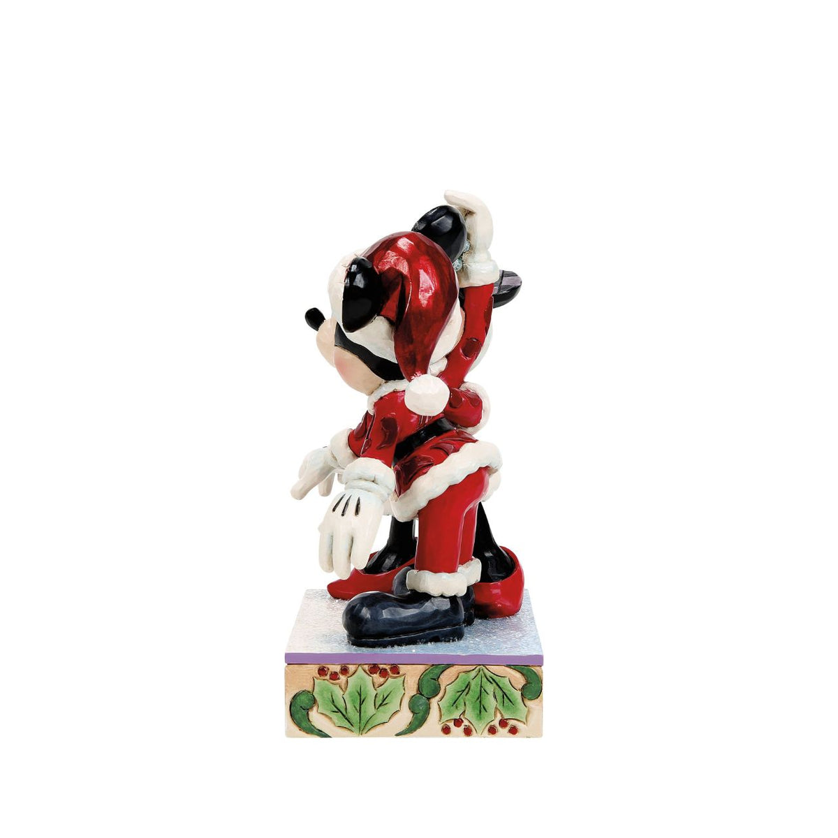 Romance fills the air as Mickey and Minnie Mouse share a kiss beneath the mistletoe in this darling Jim Shore creation. With festive details and folk art charm, it's a heartwarming reminder of holiday love and cheerful Christmas traditions.