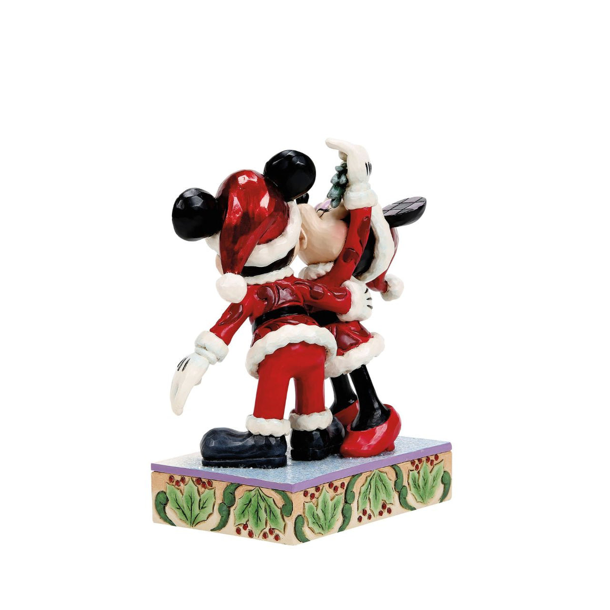 Romance fills the air as Mickey and Minnie Mouse share a kiss beneath the mistletoe in this darling Jim Shore creation. With festive details and folk art charm, it's a heartwarming reminder of holiday love and cheerful Christmas traditions.