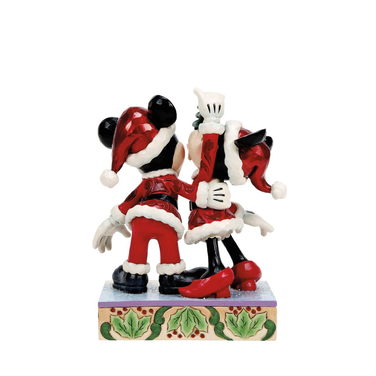 Romance fills the air as Mickey and Minnie Mouse share a kiss beneath the mistletoe in this darling Jim Shore creation. With festive details and folk art charm, it's a heartwarming reminder of holiday love and cheerful Christmas traditions.