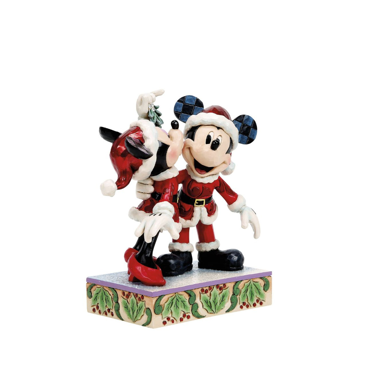 Romance fills the air as Mickey and Minnie Mouse share a kiss beneath the mistletoe in this darling Jim Shore creation. With festive details and folk art charm, it's a heartwarming reminder of holiday love and cheerful Christmas traditions.