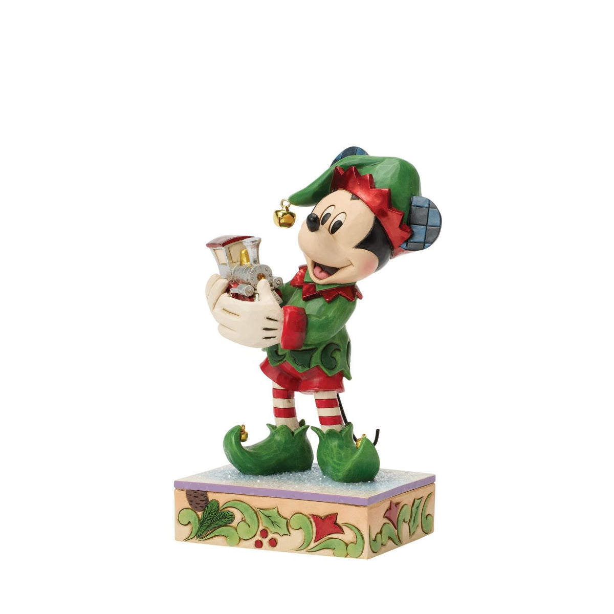Mickey is Santa's helper as he hand delivers a festive toy train in this Special Edition Jim Shore holiday bust. Featuring bright folk art details and a sparkling gem on the engine, Mickey the elf brings holiday wonder to any Christmas display.