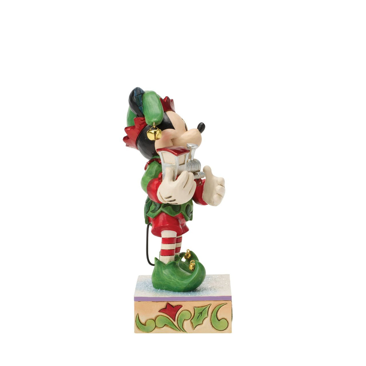 Mickey is Santa's helper as he hand delivers a festive toy train in this Special Edition Jim Shore holiday bust. Featuring bright folk art details and a sparkling gem on the engine, Mickey the elf brings holiday wonder to any Christmas display.