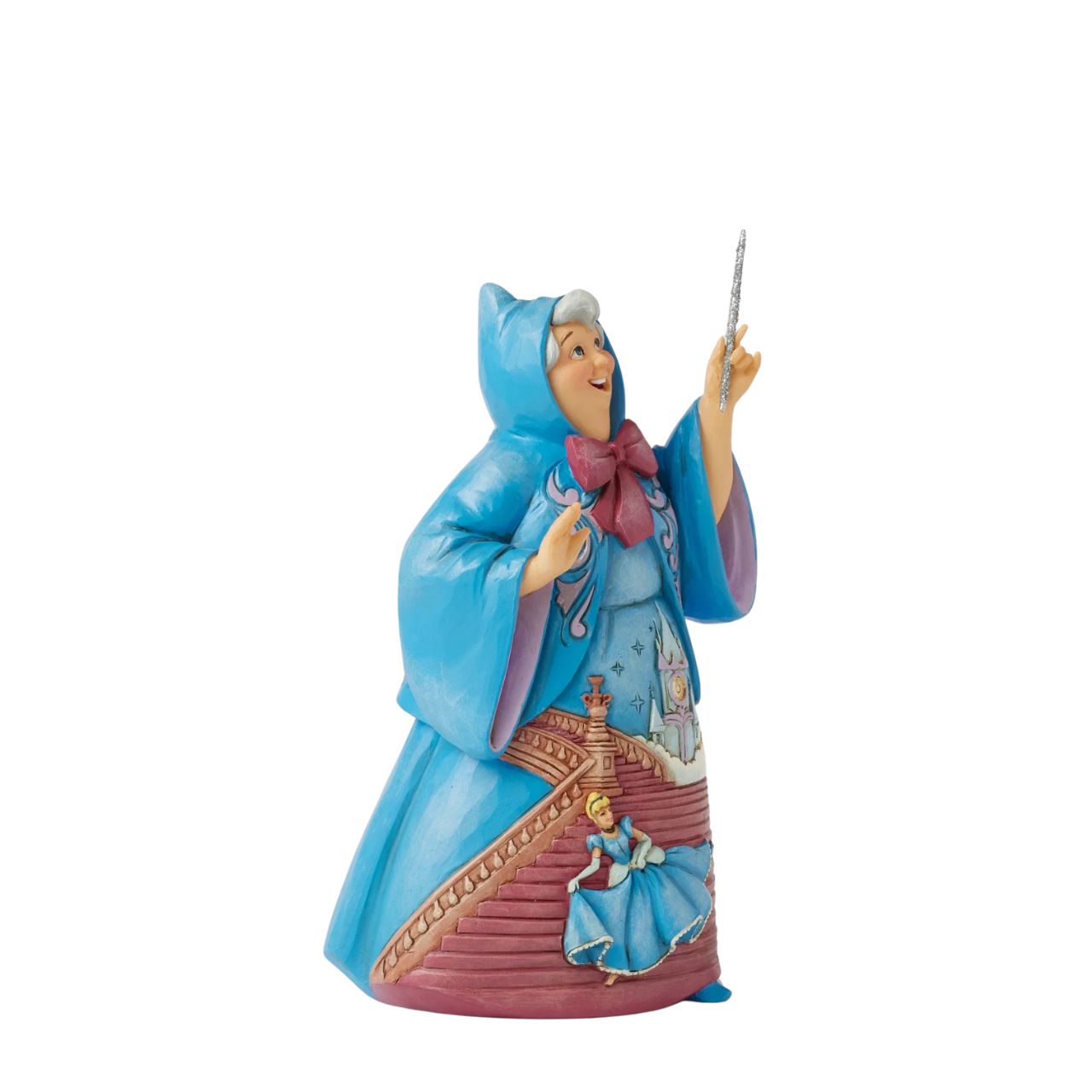 In this magical Jim Shore design, the Fairy Godmother smiles with her wand, her rosemaling blue robes parting to reveal Cinderella racing down the steps as the clock strikes midnight. This captivating moment is when she will lose her glass slipper.