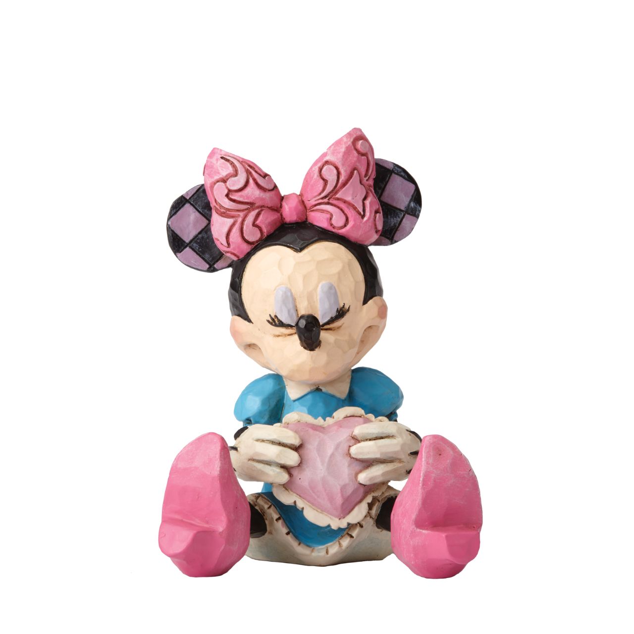 Disney Showcase Minnie Mouse with Heart Mini Figurine  Beautifully handcrafted with delightful attention to detail, Jim Shore's charming miniatures capture the essence of the beloved Disney characters. Making a wish on a heart held close, this beguiling Minnie is a heartfelt and playful romantic design.