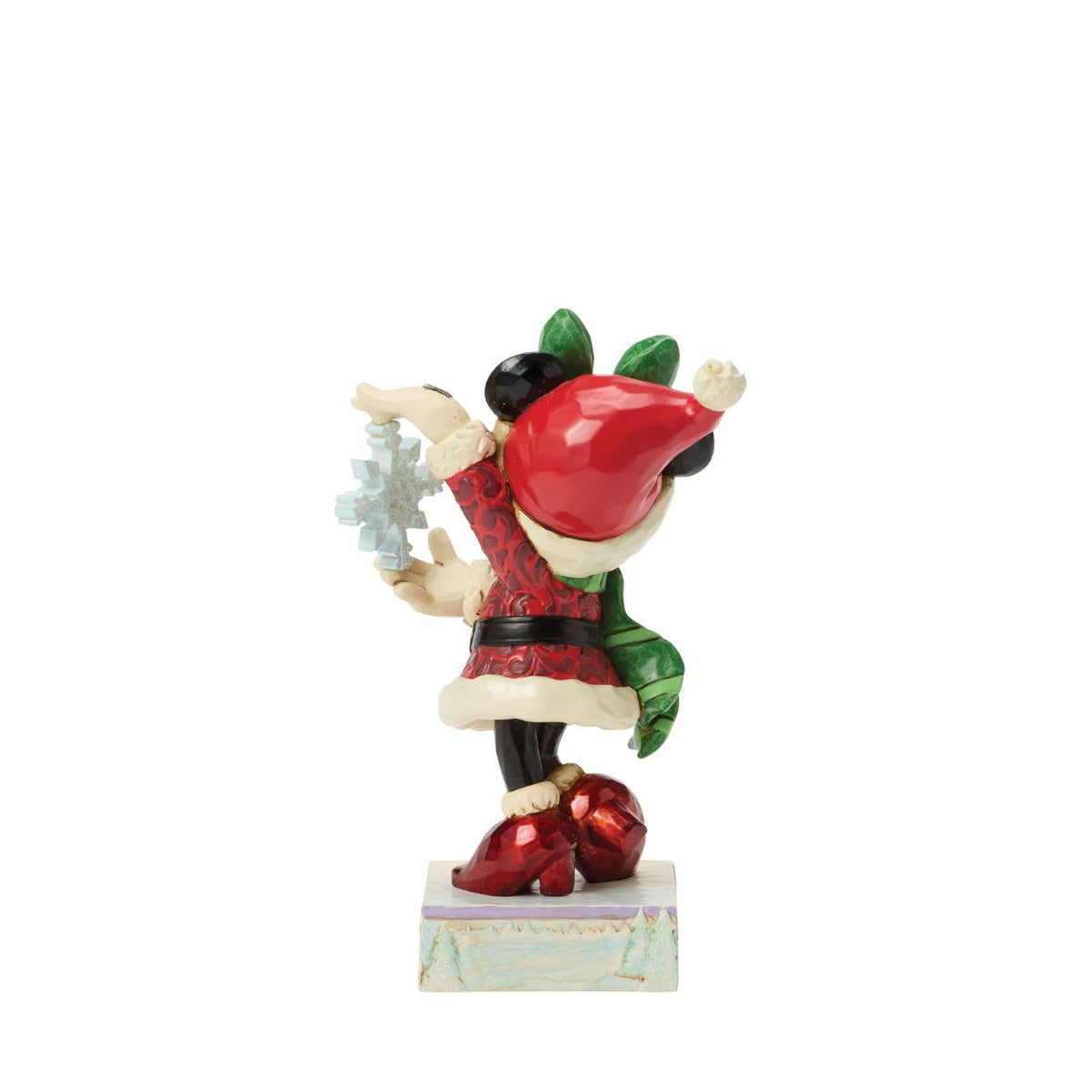 Minnie Mouse sparkles in holiday style as she holds a delicate snowflake in this Jim Shore masterpiece.