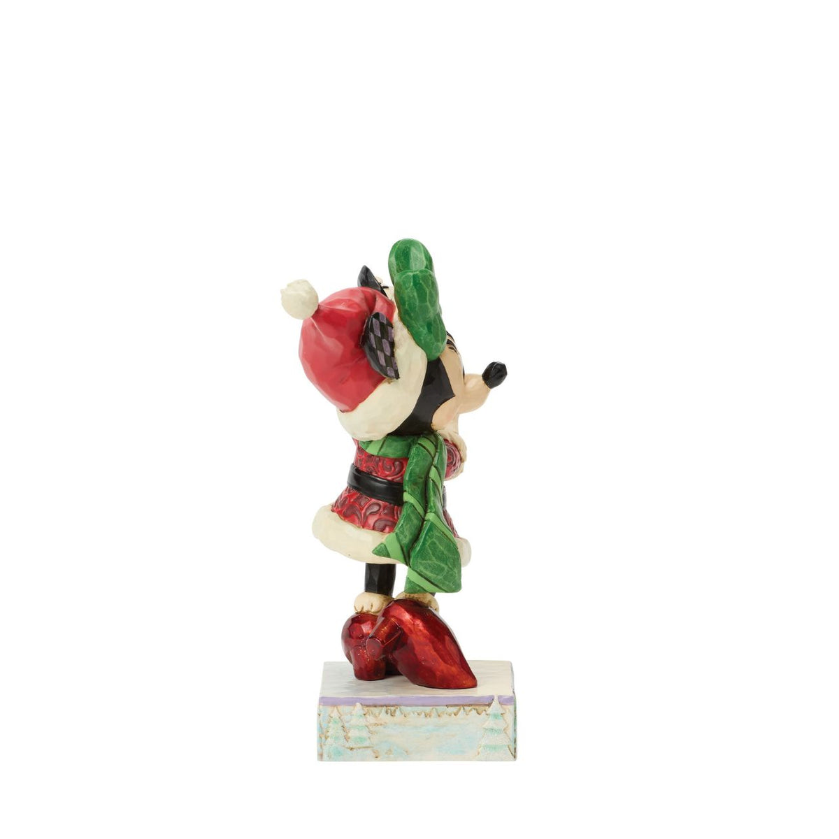 Minnie Mouse sparkles in holiday style as she holds a delicate snowflake in this Jim Shore masterpiece.