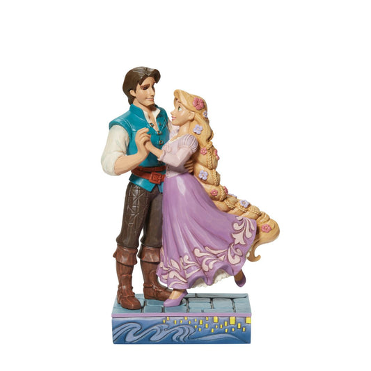 Based on the beloved characters from the 2010 film Tangled, this piece showcases Rapunzel &amp; Flynn Rider happy together. Designed by award winning artist Jim Shore, hand crafted using high quality cast stone and hand painted.