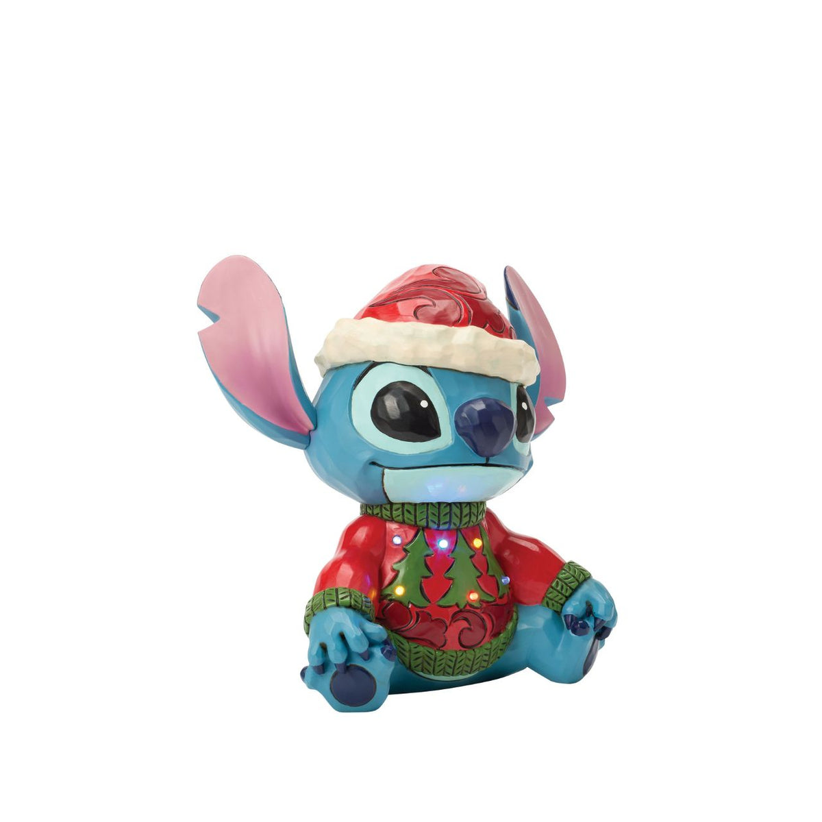 Stitch brings holiday humour to life in this glowing Jim Shore bust with an LED lit Christmas sweater. Wearing his sweater and Santa hat with a smile, the mischievous alien proves holiday magic spans across the universe with festive folk art style.