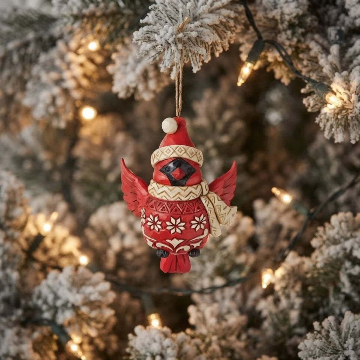 Tweet your heart out alongside this cheery cardinal ornament. Wearing a patterned Santa hat and matching scarf, this charismatic cutie seems to flutter between your tree's branches with holiday excitement. With folksy patterned plumage, he soars.