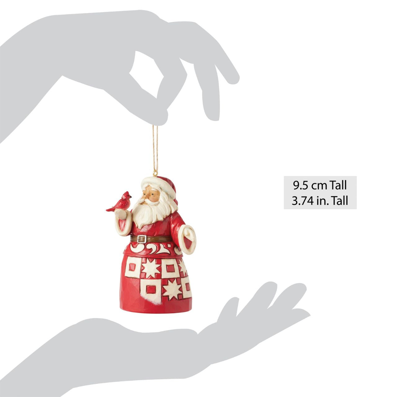 This charming Nordic Noel Jim Shore ornament features Santa holding a vibrant cardinal, embodying the joy of the season. His coat showcases the artist's iconic patchwork patterning and delicate rosemaling, adding a delightful touch of artistry to your tree.