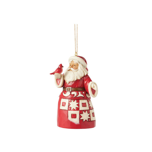 This charming Nordic Noel Jim Shore ornament features Santa holding a vibrant cardinal, embodying the joy of the season. His coat showcases the artist's iconic patchwork patterning and delicate rosemaling, adding a delightful touch of artistry to your tree.