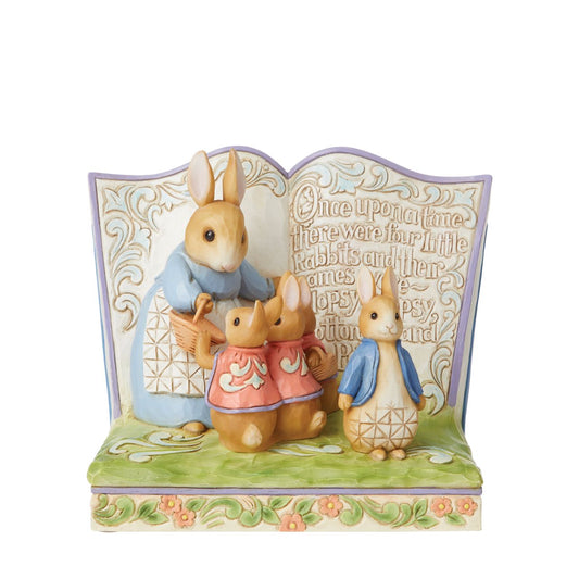 Beatrix Potter "Once Upon a Time There Were Four Little Rabbits" Storybook  Award winning folk artist Jim Shore brings his unique style to Beatrix Potter's beloved story, The Tale of Peter Rabbit, through charming hand-crafted gifts that will delight her readers of all ages. This Jim Shore Beatrix Potter Peter Rabbit Storybook figurine features Mrs. Rabbit, Flopsy, Mopsy, Cotton-tail and Peter Rabbit.