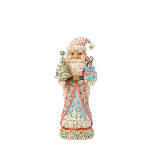 This sweet Santa nutcracker wears soft sherbet tones, blending candy-coloured charm with timeless holiday magic. Jim Shore's detailed rosemaling swirls across his coat, giving a fresh and playful twist to a traditional design.