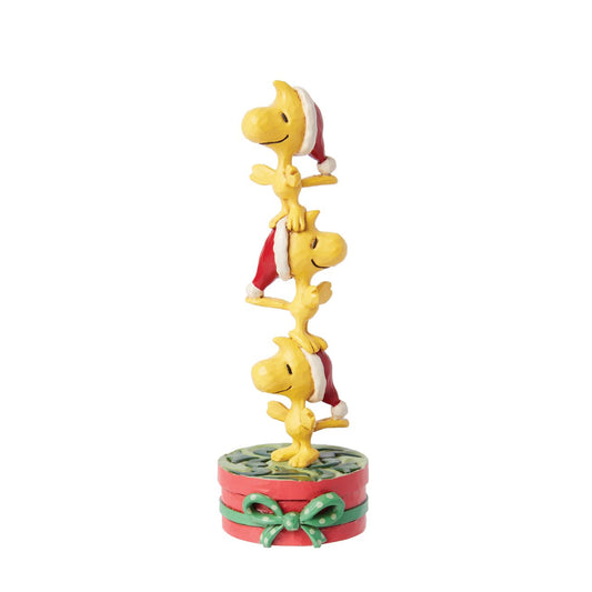 Celebrate Woodstock's 60th anniversary with this adorable creation from Jim Shore. Woodstock and his brothers don Santa hats and form a tower standing on one another's heads. With rosemale details, the trio delights with stacked holiday spirit.