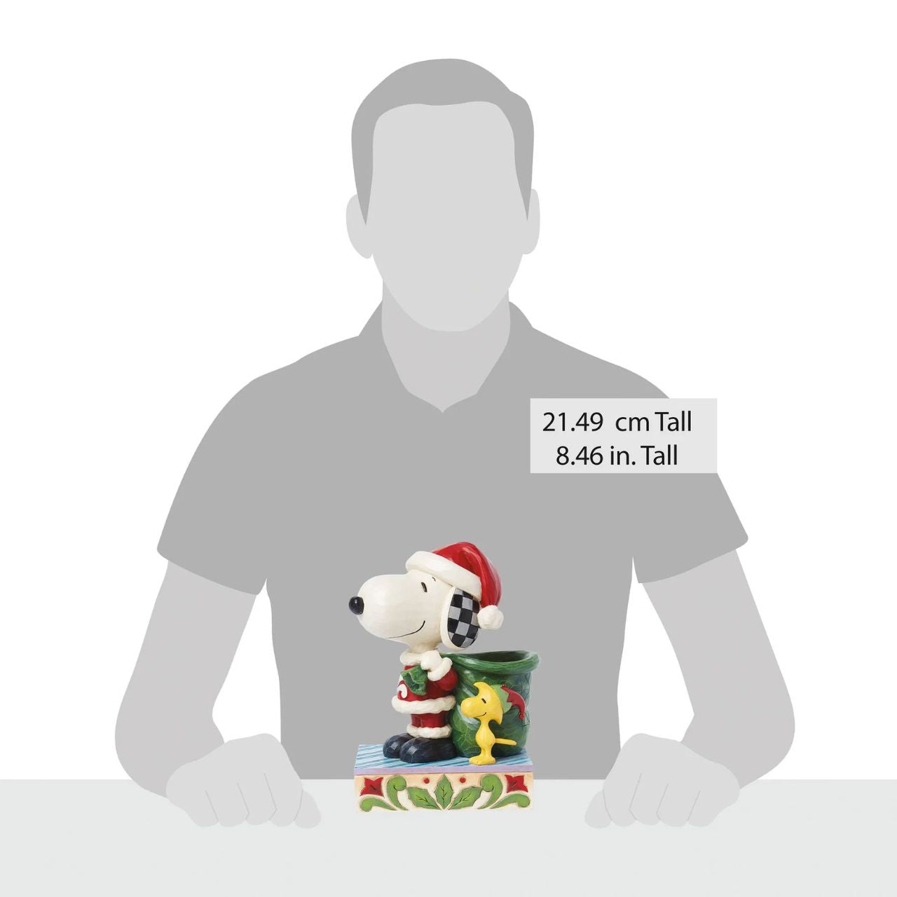 Dressed as Santa, Snoopy carries a sculpted bag deep enough to hold real candy canes! With Woodstock by his side, the patterned pair prepare for a holiday spent spreading joy and laughter. Celebrate the season with this Jim Shore Peanuts design.