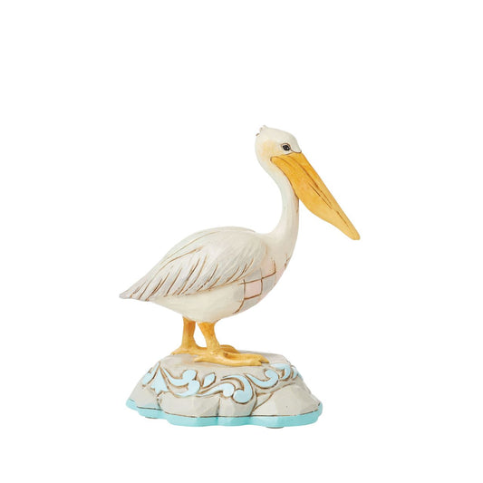Embrace coastal charm with this magnificent Jim Shore pelican figurine, adorned with the artist's distinctive patchwork patterning, capturing the essence of seaside beauty. This stunning piece brings a touch of coastal elegance to any space.