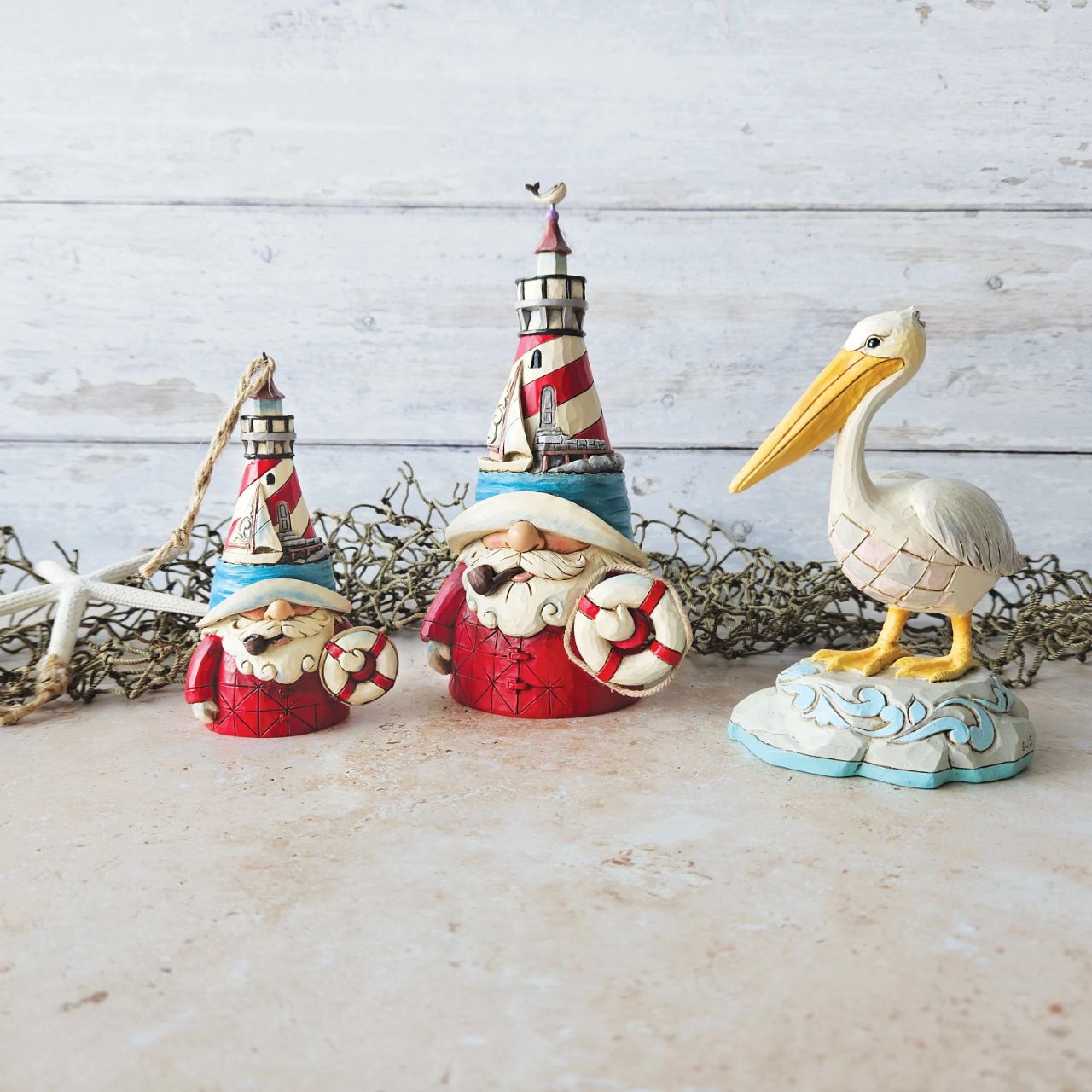 Embrace coastal charm with this magnificent Jim Shore pelican figurine, adorned with the artist's distinctive patchwork patterning, capturing the essence of seaside beauty. This stunning piece brings a touch of coastal elegance to any space.
