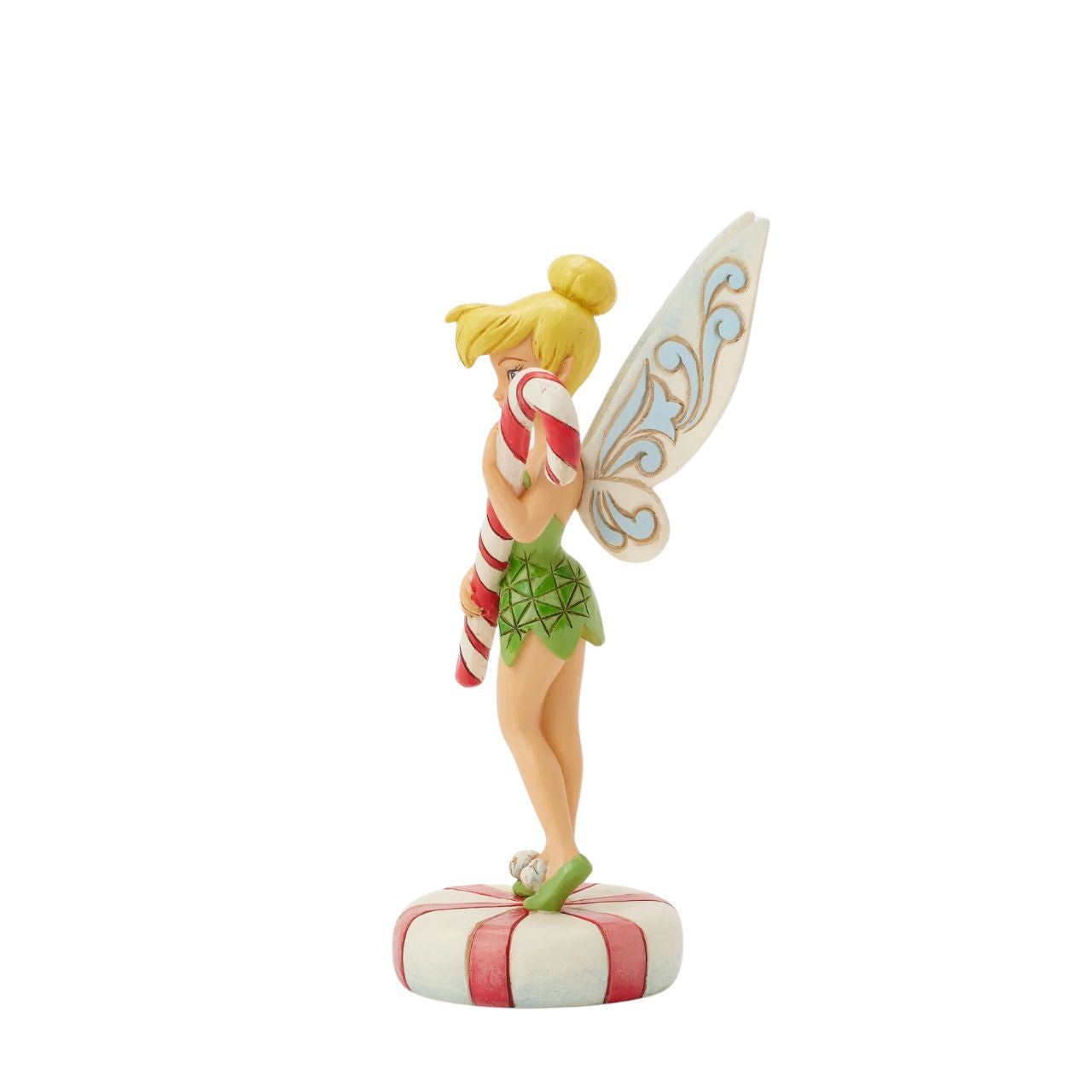 In this enchanting Jim Shore design, Tinker Bell stands atop a vibrant peppermint, delicately holding a candy cane with a sweet smile that radiates holiday warmth. Her enchanting presence brings a touch of pixie dust and magic to the holiday season.