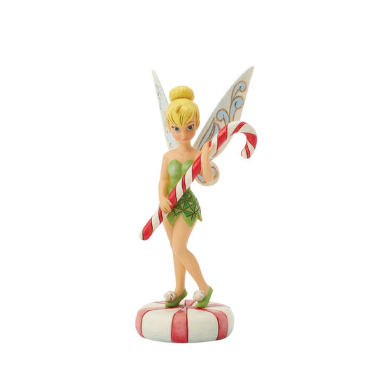 In this enchanting Jim Shore design, Tinker Bell stands atop a vibrant peppermint, delicately holding a candy cane with a sweet smile that radiates holiday warmth. Her enchanting presence brings a touch of pixie dust and magic to the holiday season.