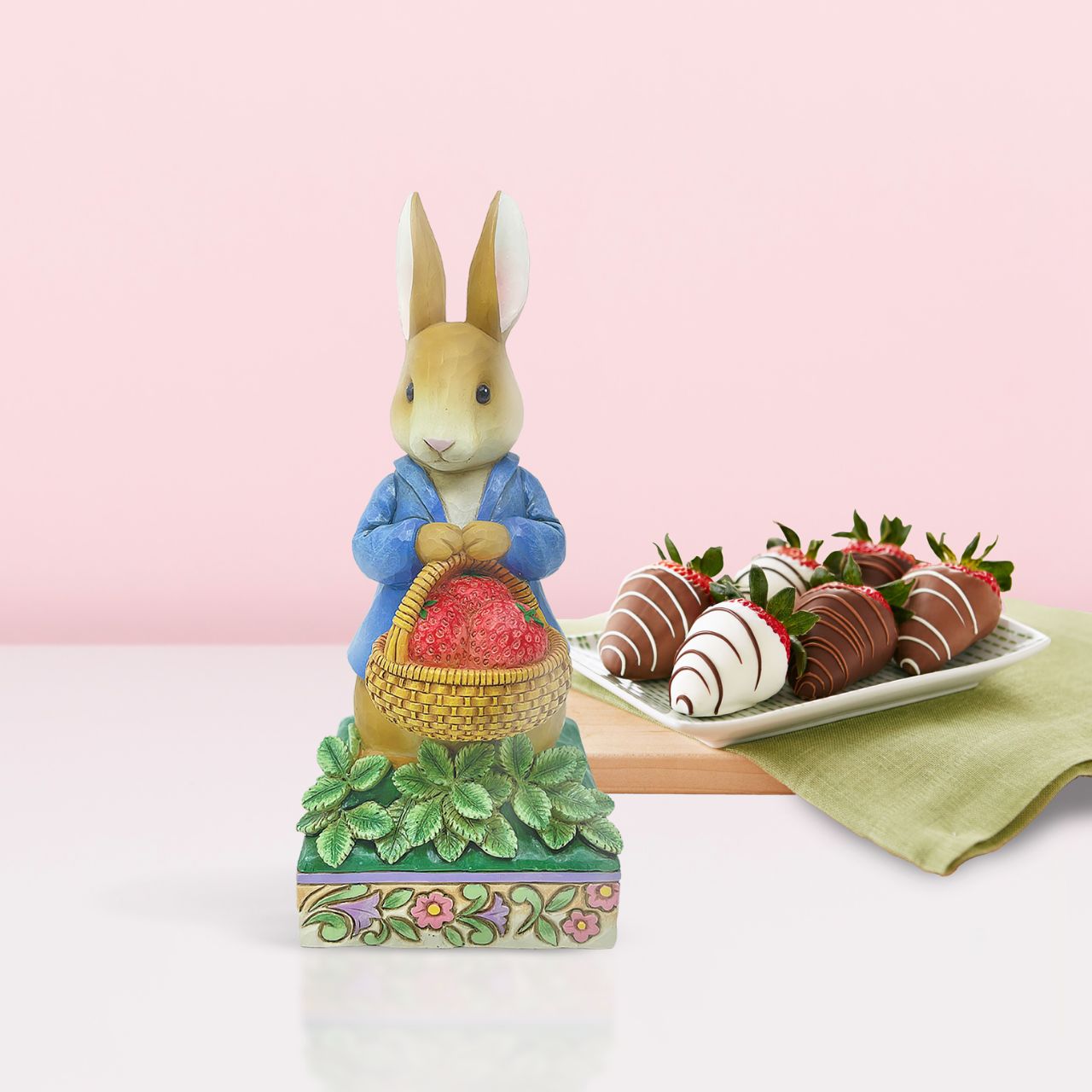 Peter Rabbit with Basket of Strawberries Figurine Made from cast stone. Packed in a branded gift box. Unique variations should be expected as this product is hand painted. Not a toy or children's product. Intended for adults.