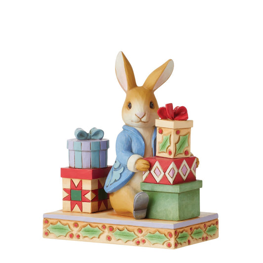 Beatrix Potter Peter with Presents Figurine by Jim Shore  2022 celebrates Peter Rabbit's 120th anniversary. Jim Shore celebrates Beatrix Potter's lovable cast of characters with charming craftsmanship. This endearing figurine features the esteemed Peter Rabbit on Christmas day surrounded by handsomely packaged presents.