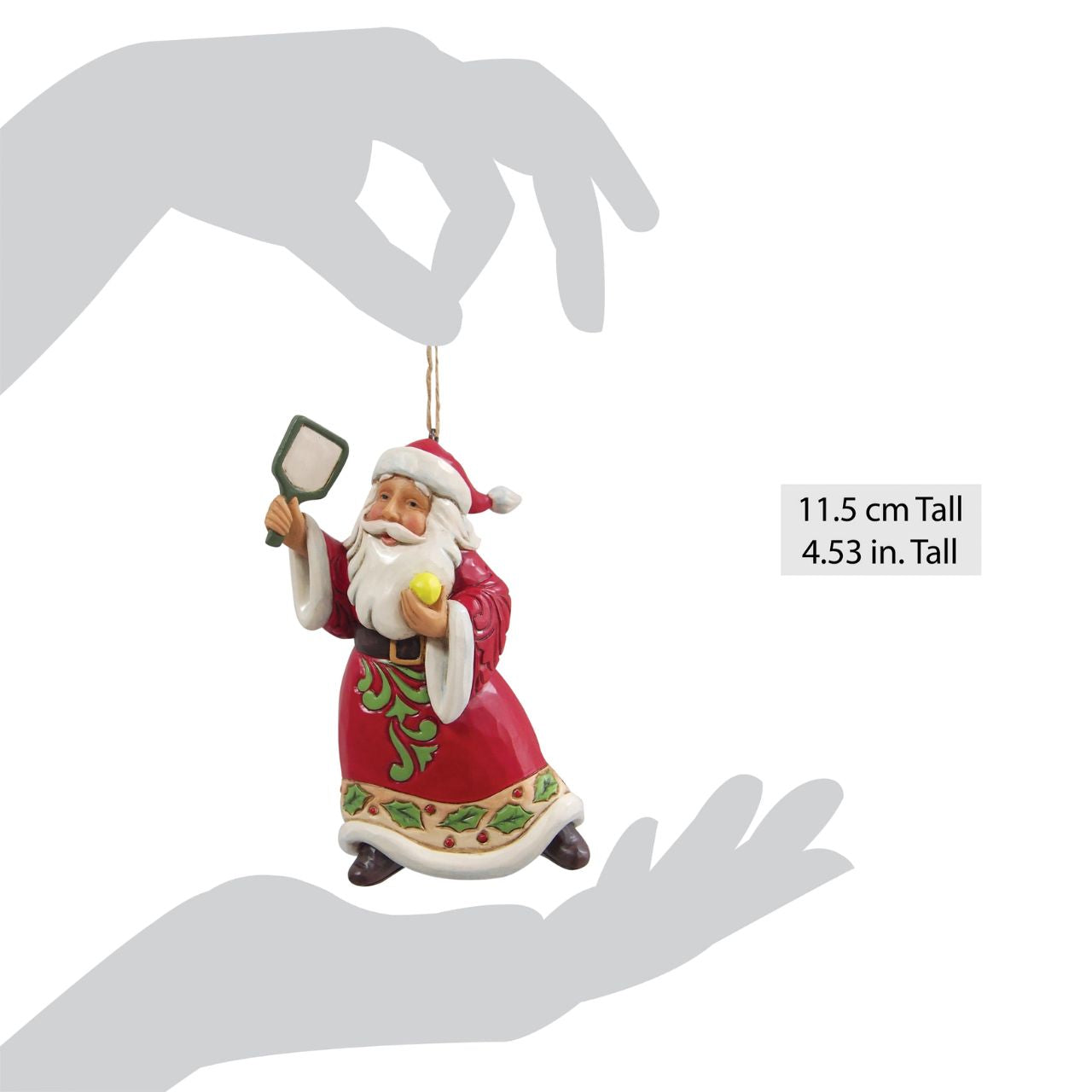 This whimsical Jim Shore Christmas ornament showcases Santa holding a pickleball and racket, ready to serve up both Christmas cheer and a winning game. Dressed in robes adorned with rosemaling and holly, Santa blends festive fun with sporty flair.