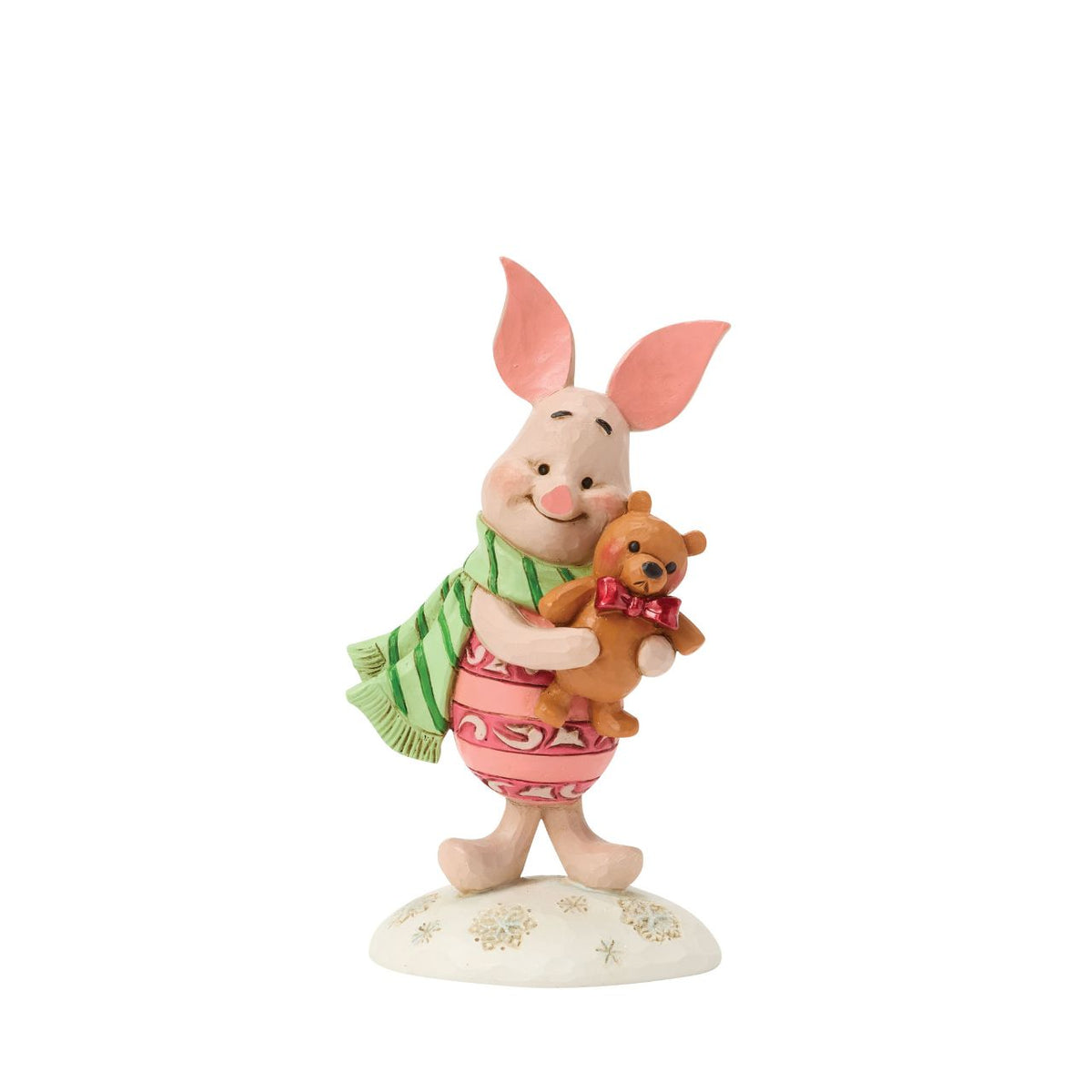 Piglet shines with holiday sweetness in this petite Jim Shore holiday design. Dressed for the season in a cosy scarf, Piglet is brimming with charm, as they hug a stuffed bear with the gentle joy of the Hundred Acre Wood in collectible size.