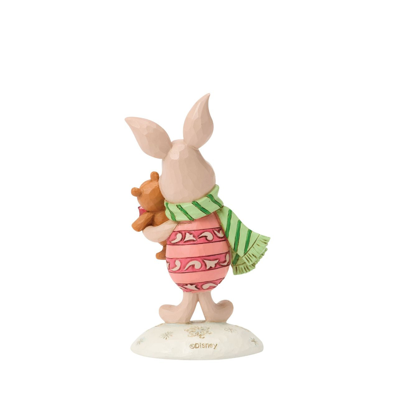 Piglet shines with holiday sweetness in this petite Jim Shore holiday design. Dressed for the season in a cosy scarf, Piglet is brimming with charm, as they hug a stuffed bear with the gentle joy of the Hundred Acre Wood in collectible size.