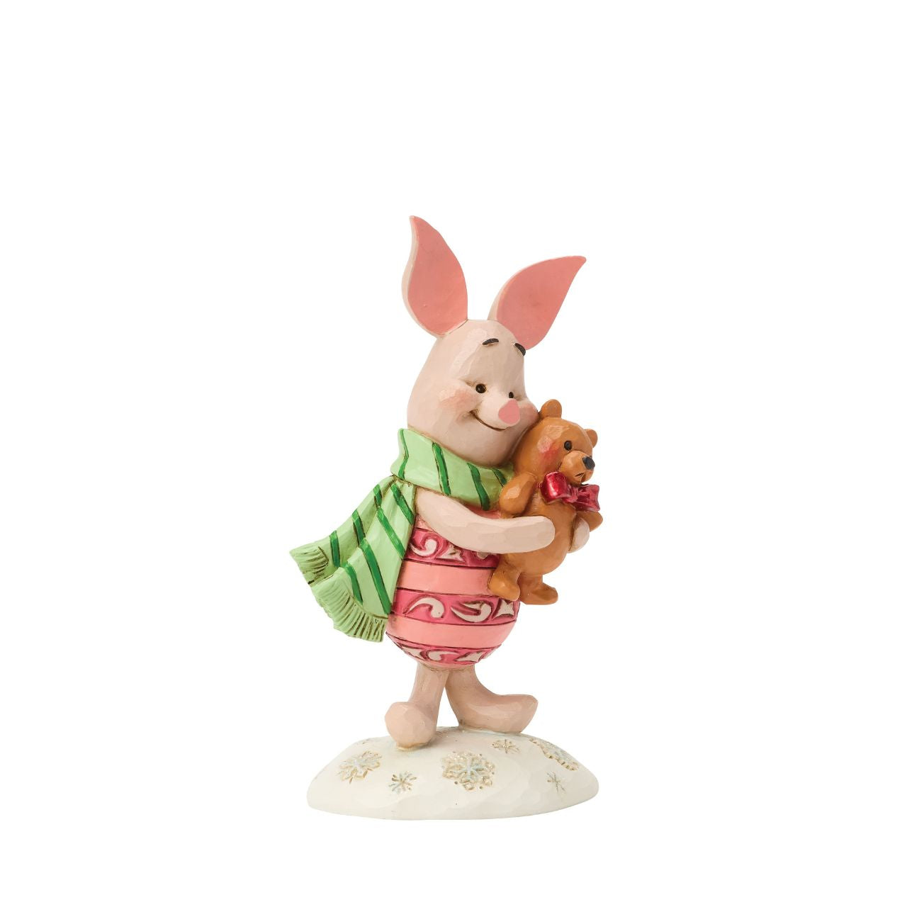 Piglet shines with holiday sweetness in this petite Jim Shore holiday design. Dressed for the season in a cosy scarf, Piglet is brimming with charm, as they hug a stuffed bear with the gentle joy of the Hundred Acre Wood in collectible size.