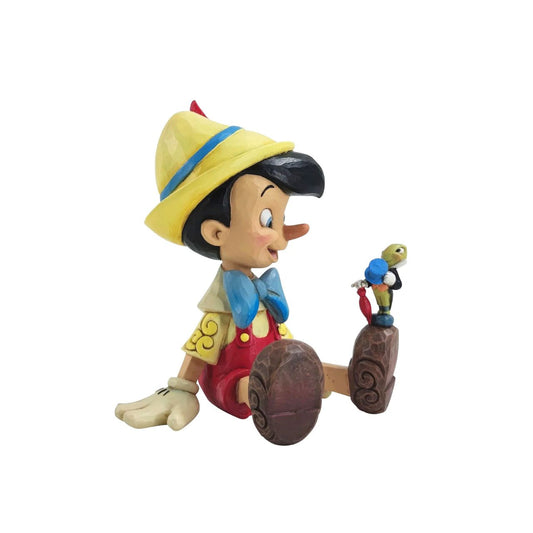 "Wishful and Wise" Jiminy Cricket is quite the dapper conscience in this design by Jim Shore, giving a tip o' his top hat as he smiles and gives his bestie Pinocchio a lesson about temptations.