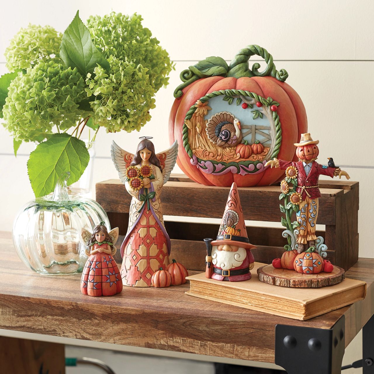 Heartwood Creek Pumpkin Fairy Figurine  Handcrafted in breath-taking detail, this beautiful Pumpkin Fairy Mini Figurine is beautifully decorated in Jim Shore's subtle combination of traditional quilt. Hands clasped delicately, the pumpkin fairy smiles softly, wings spread wide.