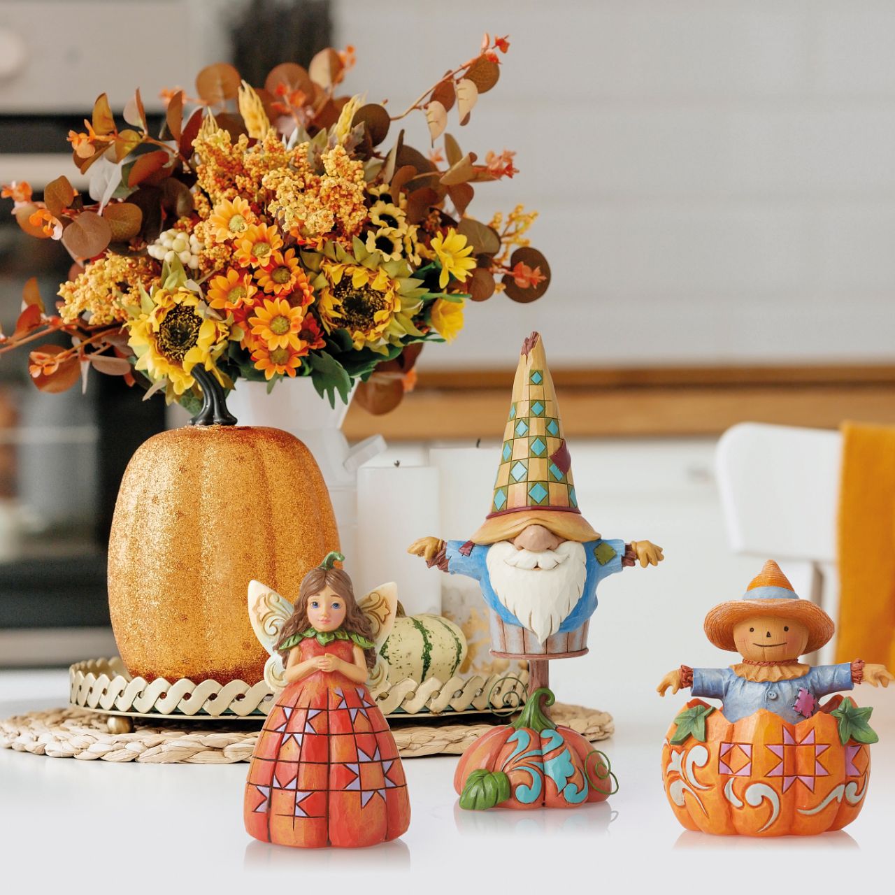 Heartwood Creek Pumpkin Fairy Figurine  Handcrafted in breath-taking detail, this beautiful Pumpkin Fairy Mini Figurine is beautifully decorated in Jim Shore's subtle combination of traditional quilt. Hands clasped delicately, the pumpkin fairy smiles softly, wings spread wide.