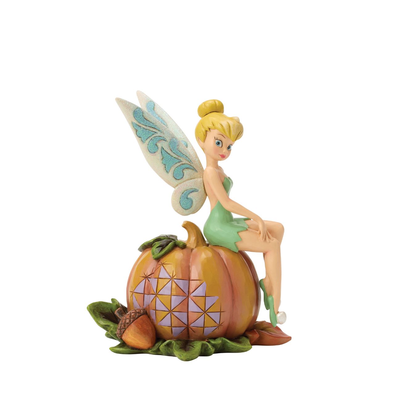 Tinker Bell adds a touch of pixie dust to Halloween magic in this charming Jim Shore design. Dressed in festive autumn colours, she sits gracefully on a pumpkin, blending Disney whimsy with folk-art charm.