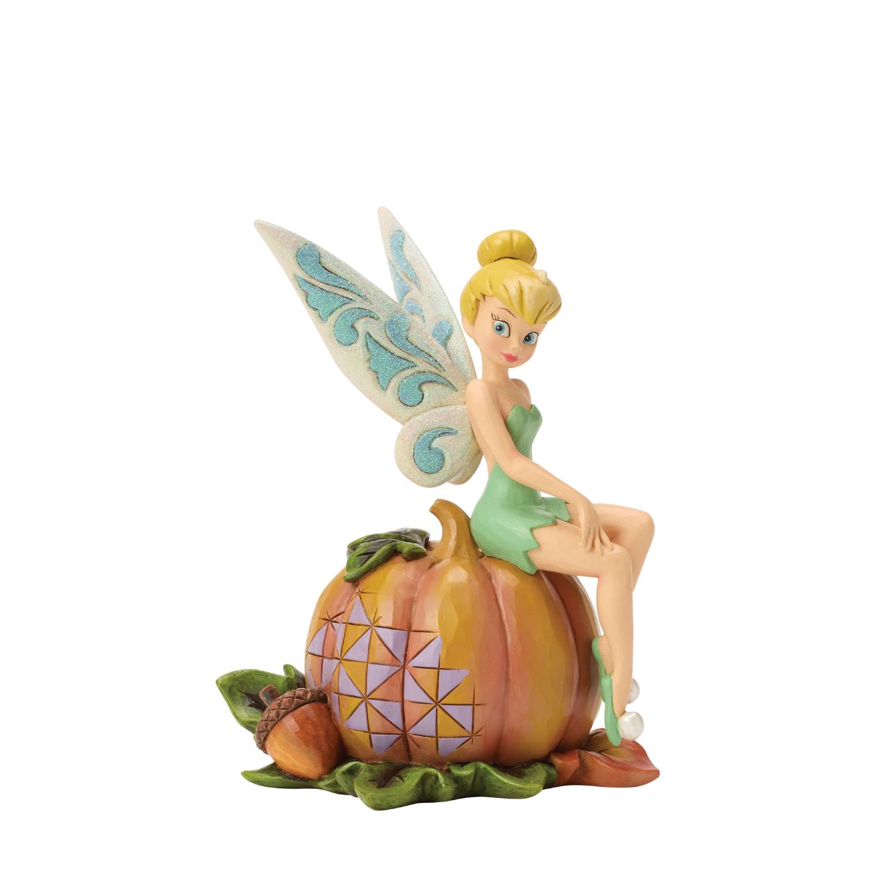 Tinker Bell adds a touch of pixie dust to Halloween magic in this charming Jim Shore design. Dressed in festive autumn colours, she sits gracefully on a pumpkin, blending Disney whimsy with folk-art charm.