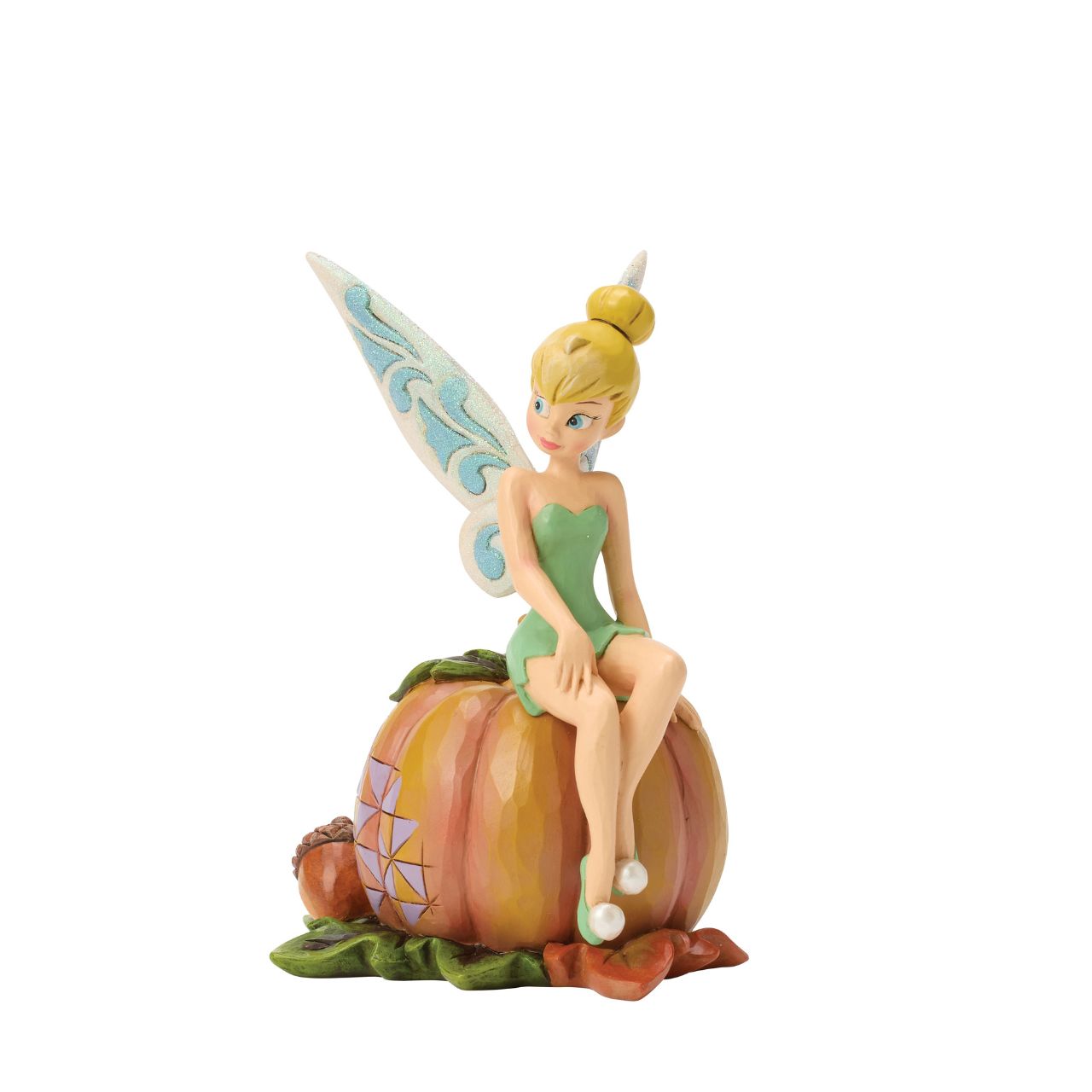 Tinker Bell adds a touch of pixie dust to Halloween magic in this charming Jim Shore design. Dressed in festive autumn colours, she sits gracefully on a pumpkin, blending Disney whimsy with folk-art charm.