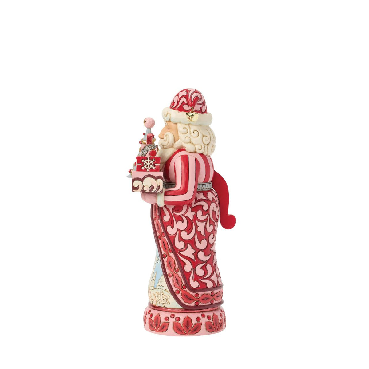 Santa stands tall in pink and crimson coat with snowy trim, his beard curling in carved detail. Folk-art rosemaling swirls across his suit, hand-painted in Jim Shore's warm, festive style.