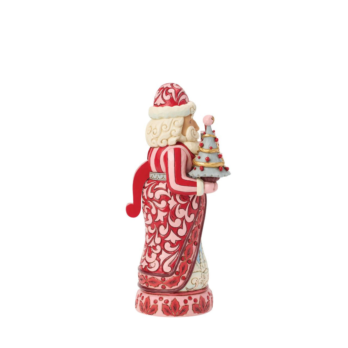 Santa stands tall in pink and crimson coat with snowy trim, his beard curling in carved detail. Folk-art rosemaling swirls across his suit, hand-painted in Jim Shore's warm, festive style.