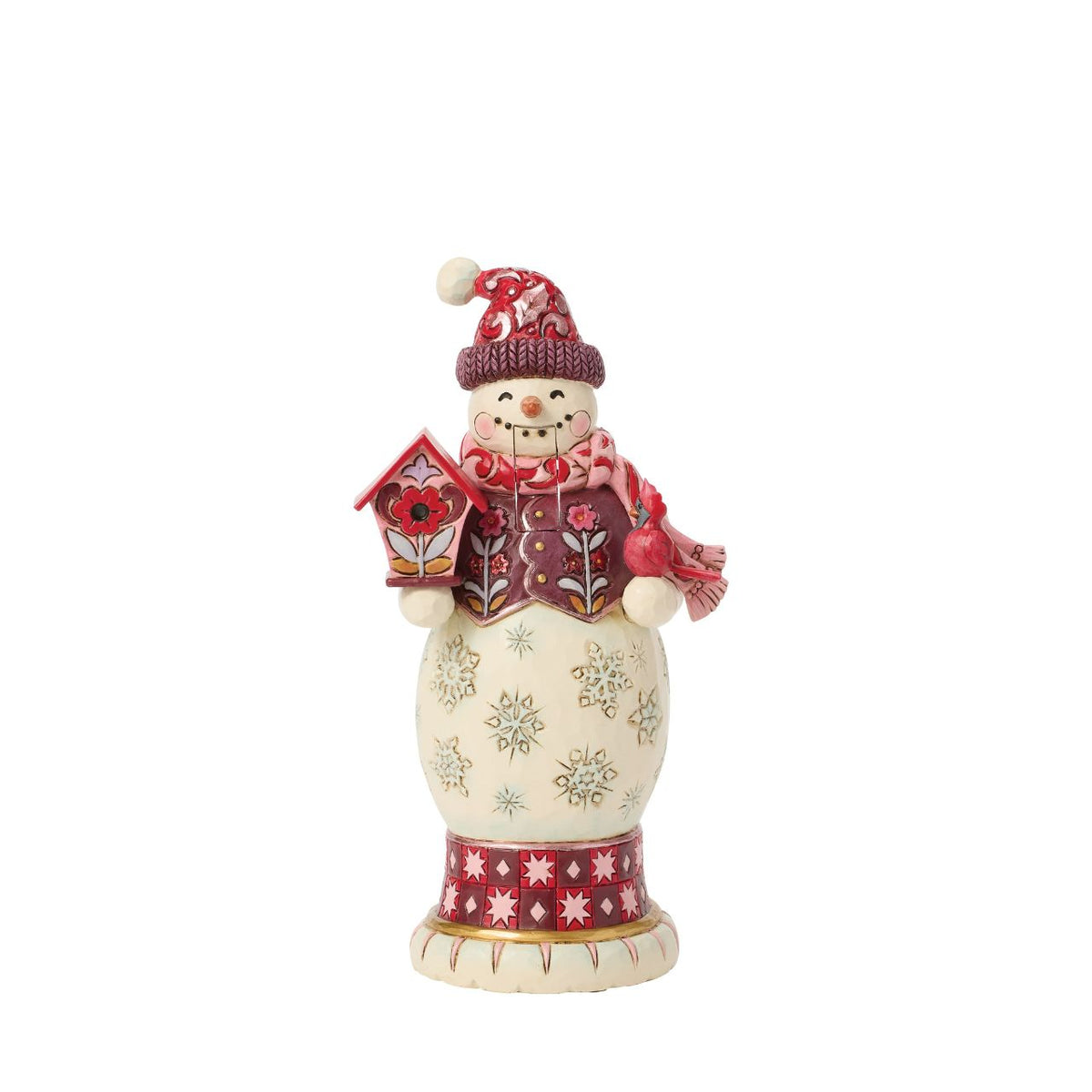 This snowman nutcracker is full of frosty personality, sporting a red top hat, cosy scarf, and cheery smile. Jim Shore's hand-painted folk designs wrap around his coat, adding rich detail and whimsy. A delightful way to bring snowy sparkle indoors.