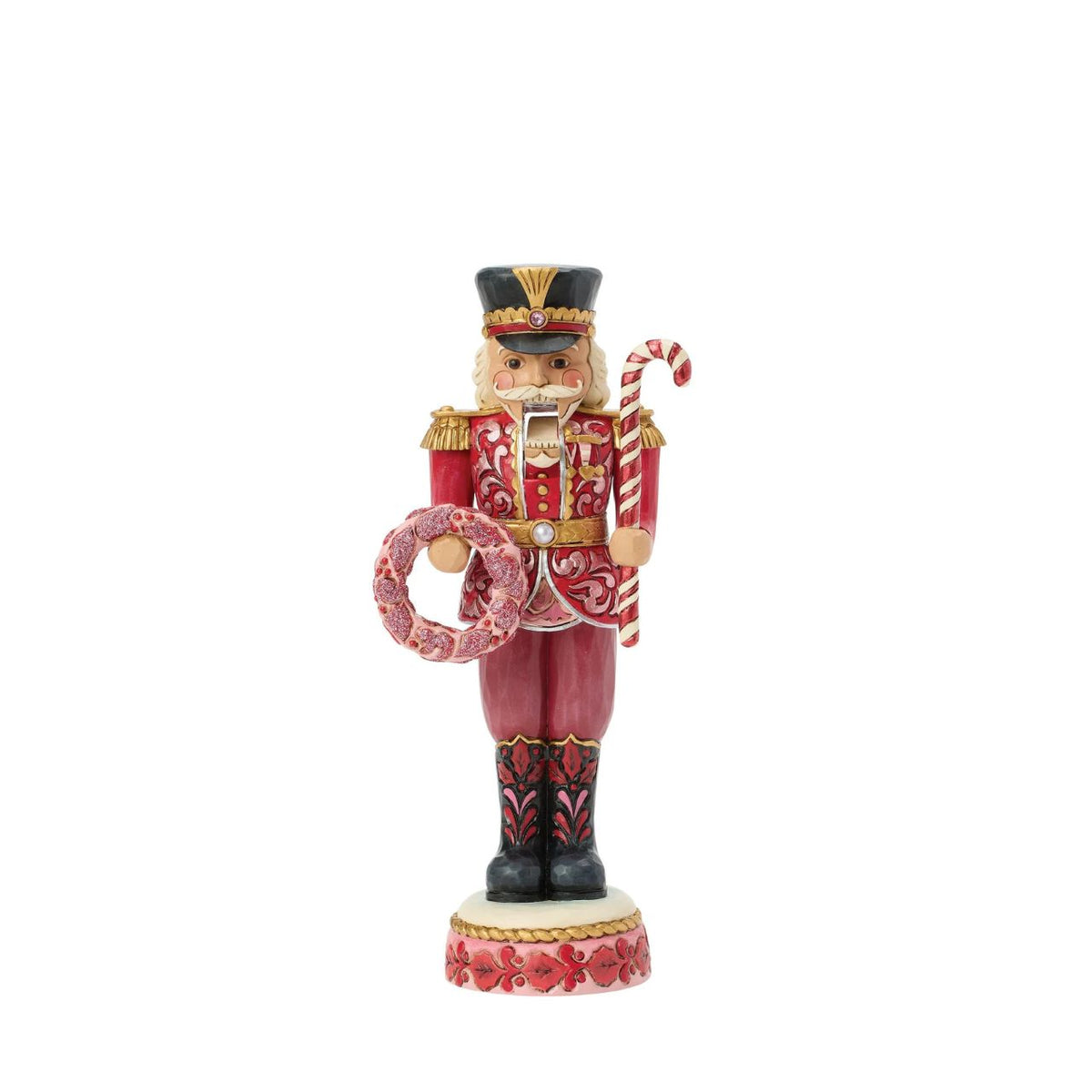 This Toy Soldier nutcracker is smartly dressed in crisp red and white with golden accents. Jim Shore's signature folk-art patterns add warmth and personality to the disciplined stance, making it a playful yet elegant holiday accent.